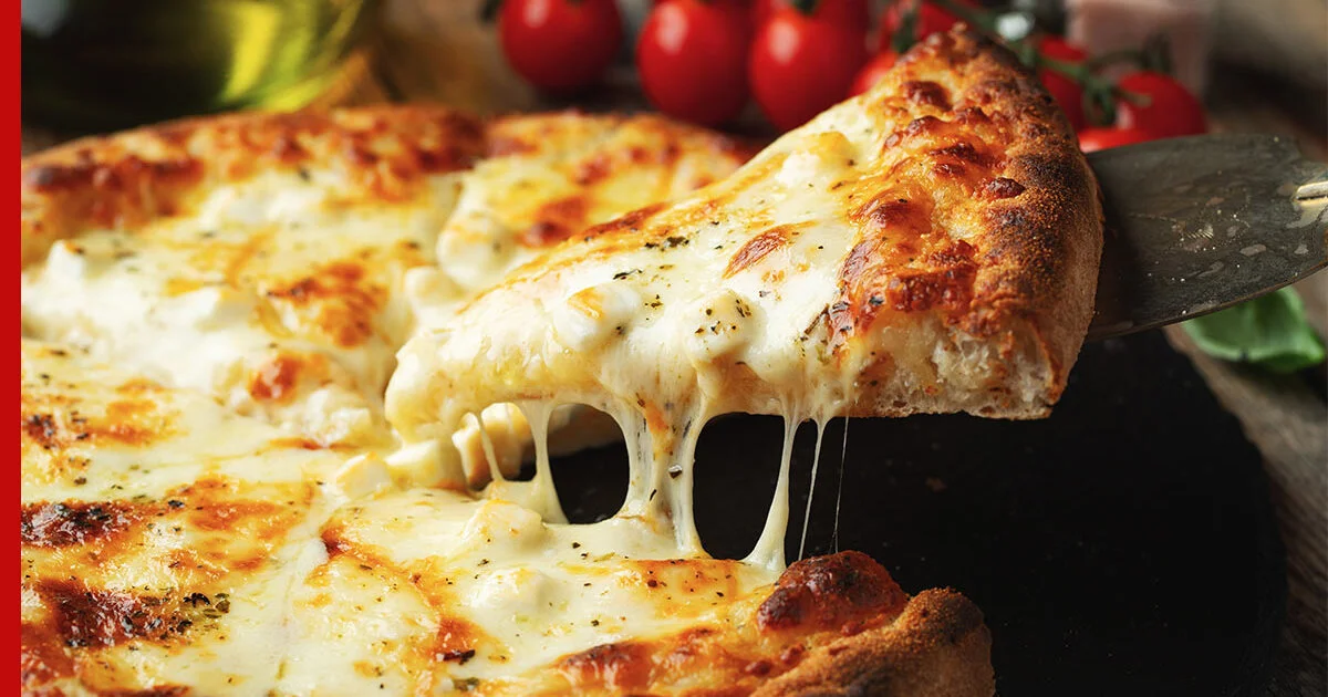 A close-up image of a cheesy pizza, raising the question: Is Pizza Safe for Cats?